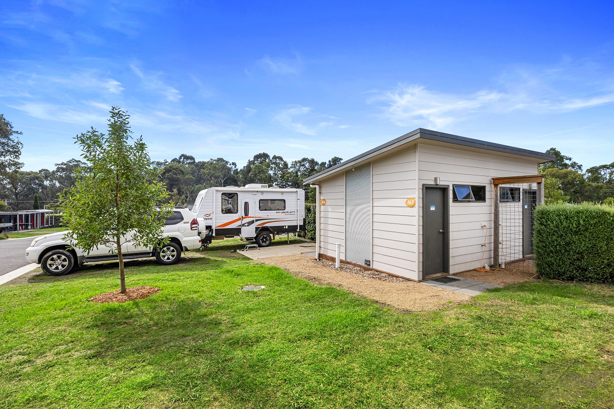 an ensuite site at Lilydale Pine Hill Caravan Park with a car and caravan next door