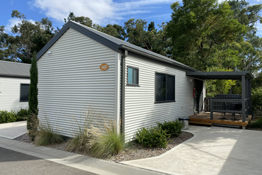 ohoto of 2 bedroom studio cabin with small deck and bike rack