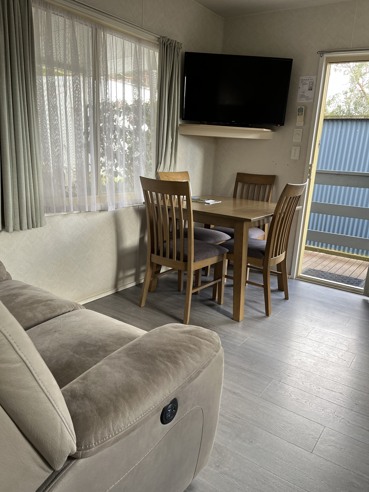 Lounge of 1 bedroom cabin at Lilydale Pine Hill Caravan Park